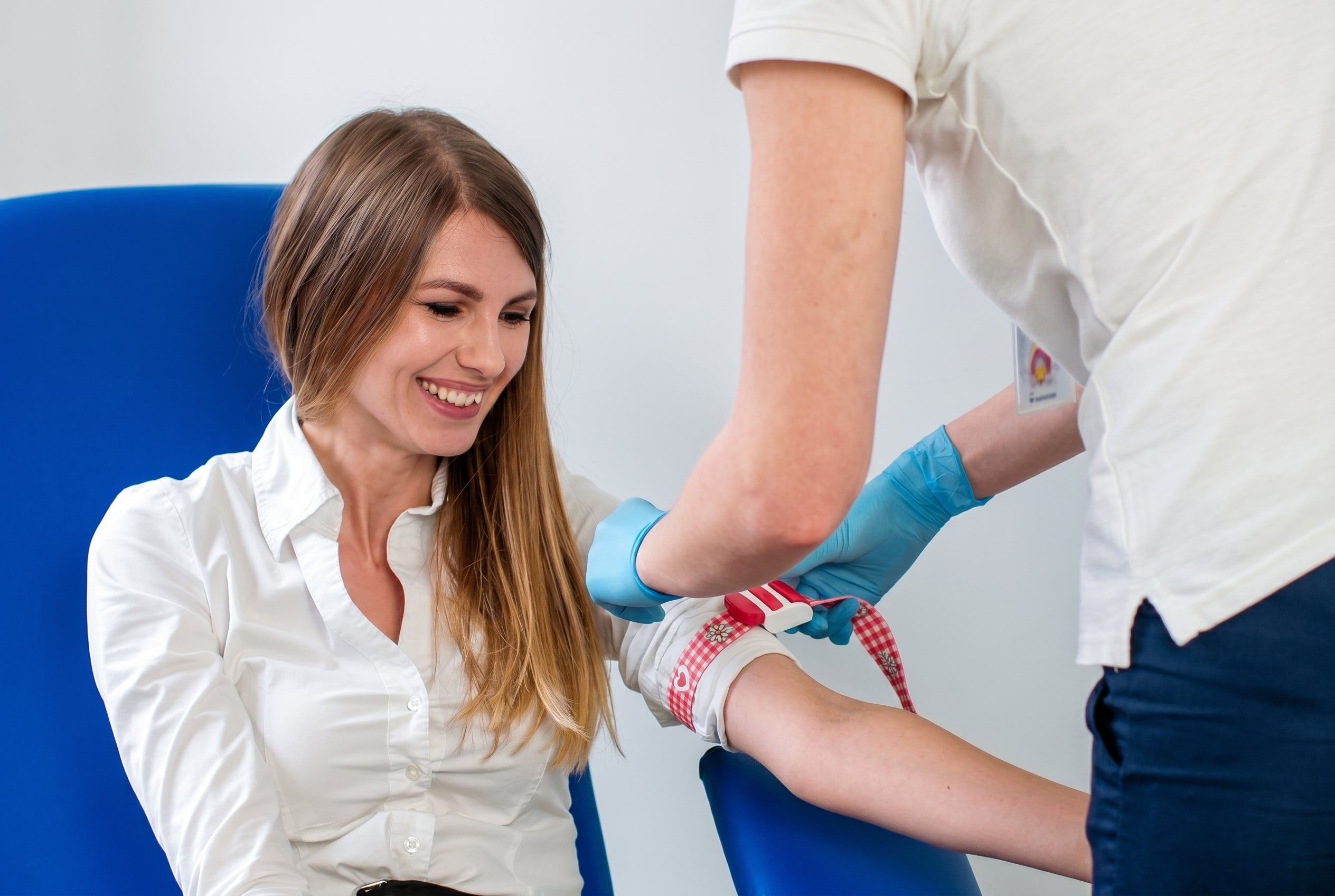 Woman getting ready to have her blood drawn by a professional.