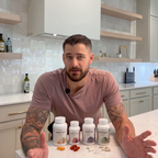 Man in a kitchen with the SageMD foundation supplement bundle on the counter.