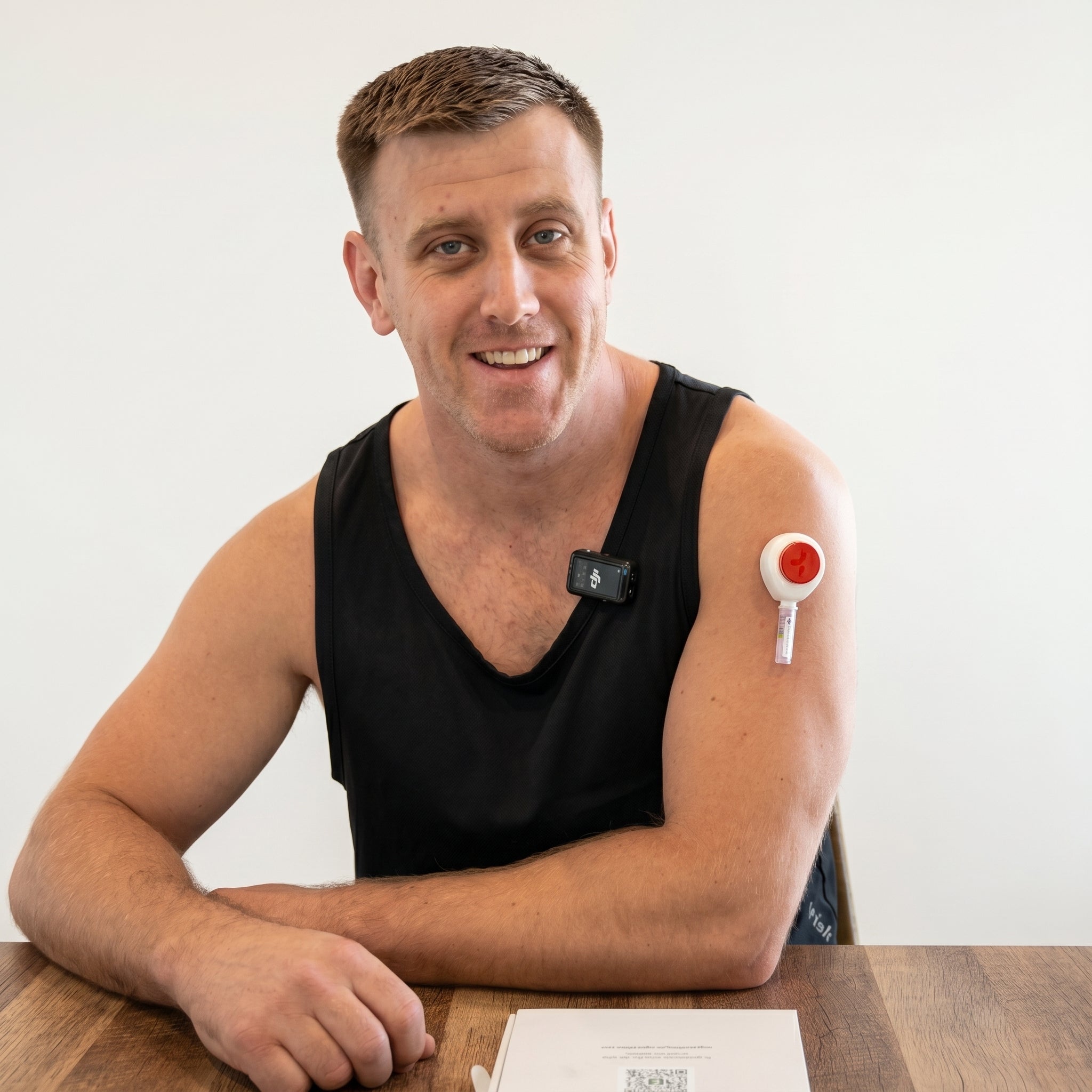 Man displaying the Tasso Blood Collection Device on their upper arm.