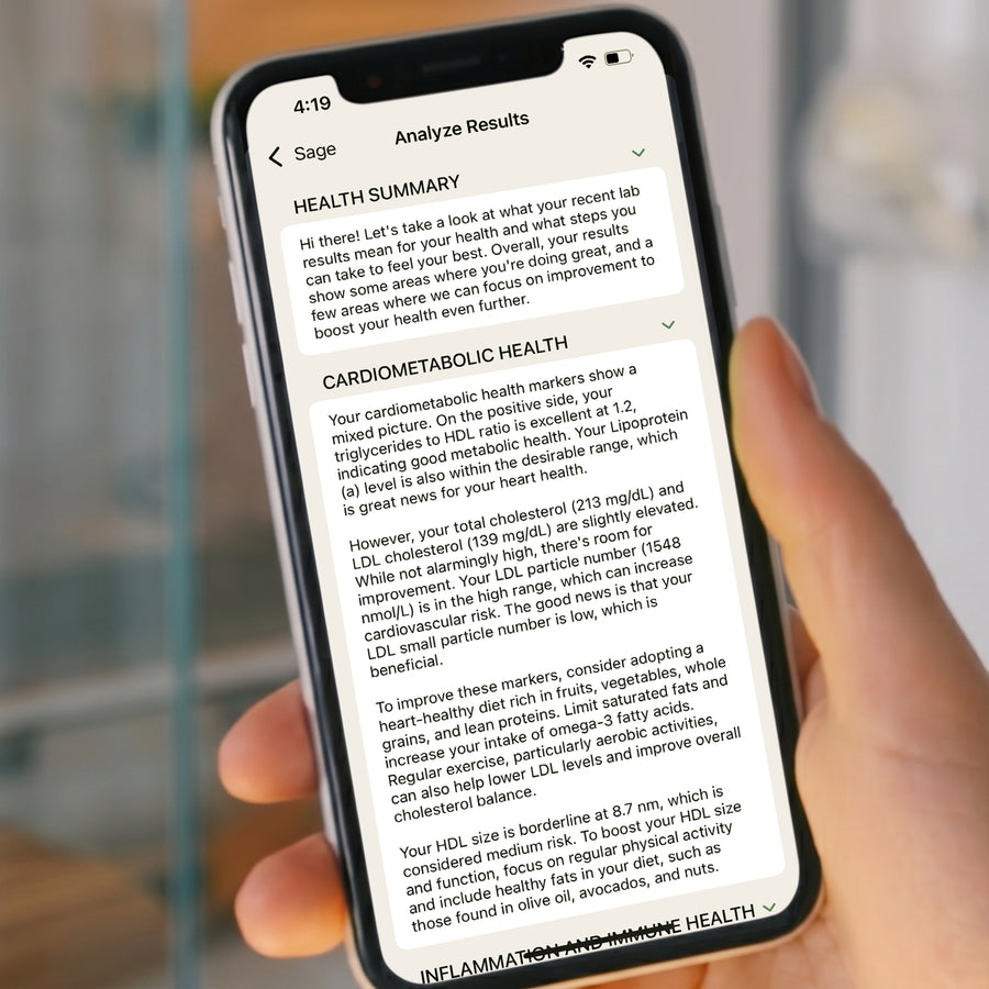 Person holding a smartphone with health summary results from the Sage health app.