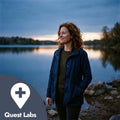 Woman standing by a lake at dusk with 'Quest Labs' logo.