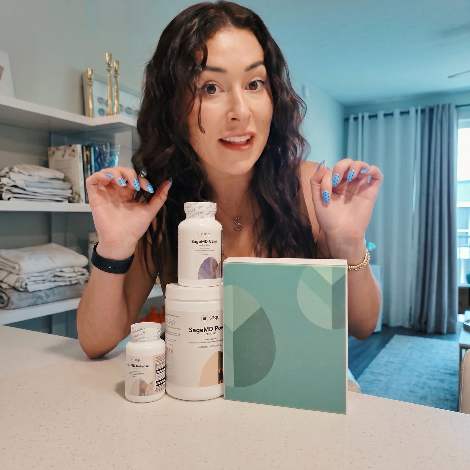 Woman showing Sage's Female Hormone Optimization Kit with Supplement Bottles and Tasso Kit Box.