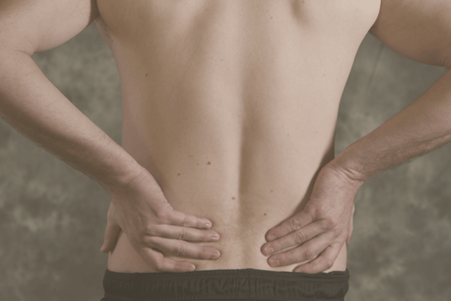 Man with hands on hips showing back.