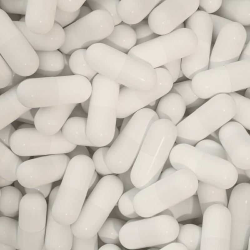 Close-up of white supplement pills.