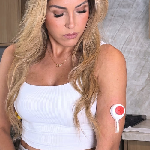 Woman with Tasso blood collection device attached to her upper arm.
